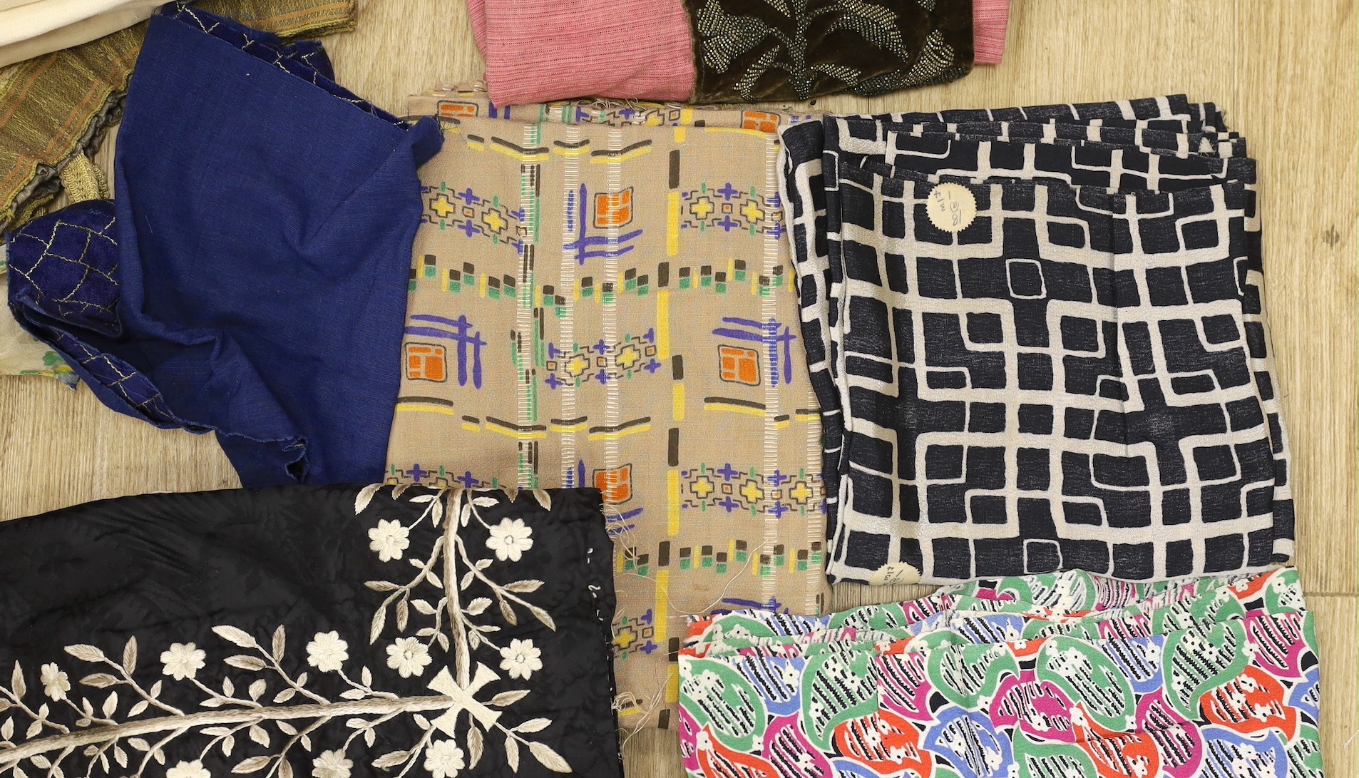 Various lengths of 1940's and later crepe, a large beaded edged cover and other fabrics, etc.